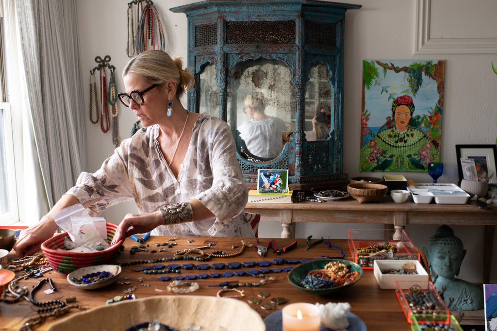 Anuschka Pashel working at a her desk with beads
