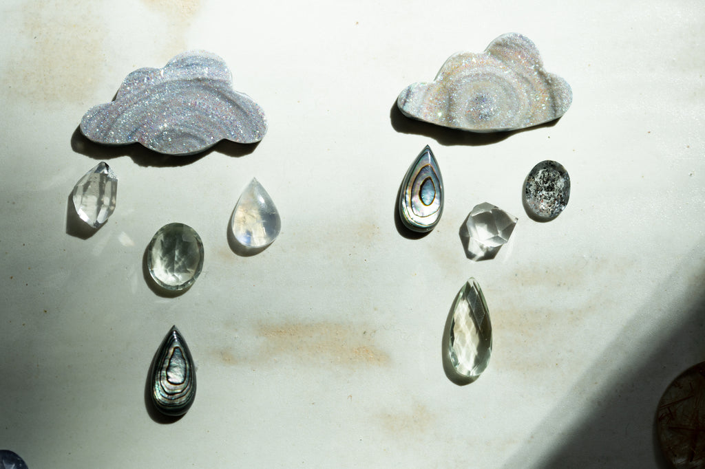 cloud and rain shaped gems on a ceramic plate