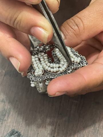 mexican artisian working on beads and silver