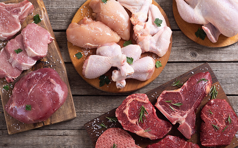 Meat and poultry on a wooden background