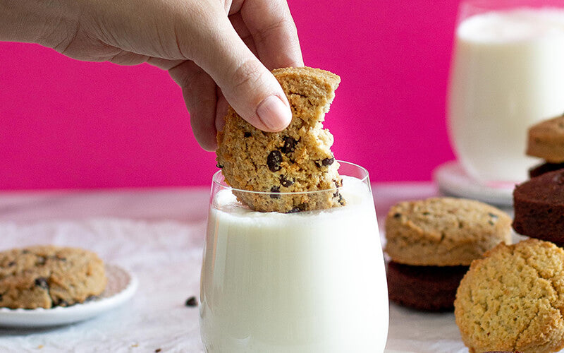 PBH Foods Keto Chocolate Chip Cookie being dunked in milk
