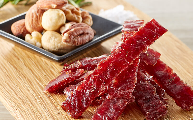 Jerky and nuts on a wooden board