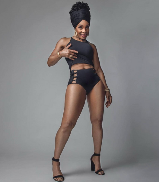 Chef Babette showing her abs in a black two-piece outfit while in a photoshoot.
