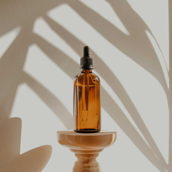 Bottle of essential oil on a small table.