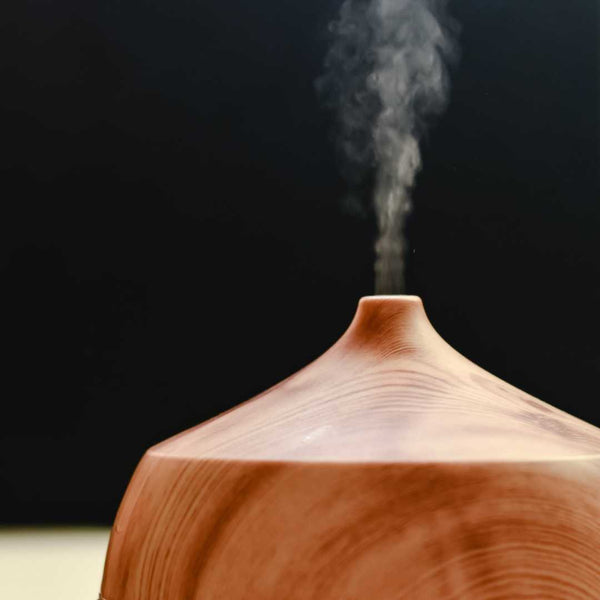 Essential oil diffuser with smoke steaming on top.