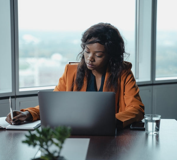 Girl boss working on a laptop in an office.