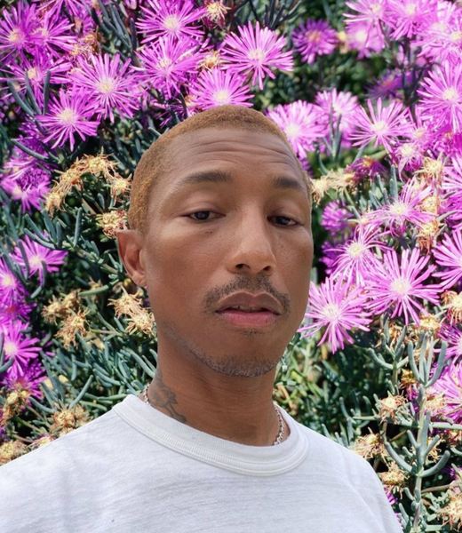 Pharrell Williams selfie with flower background.