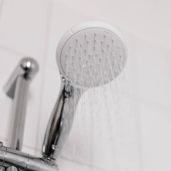 Shower head with water trickling down.