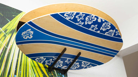 HIDEit MBoard Board Rack with two skimboards in a garage.