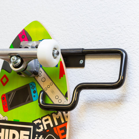 Custom HIDEit penny board being mounted in HIDEit Display Skate Mount.