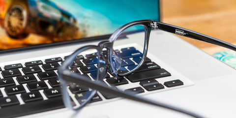 HIDEit Blue Light Blocking Glasses sitting on a Mac