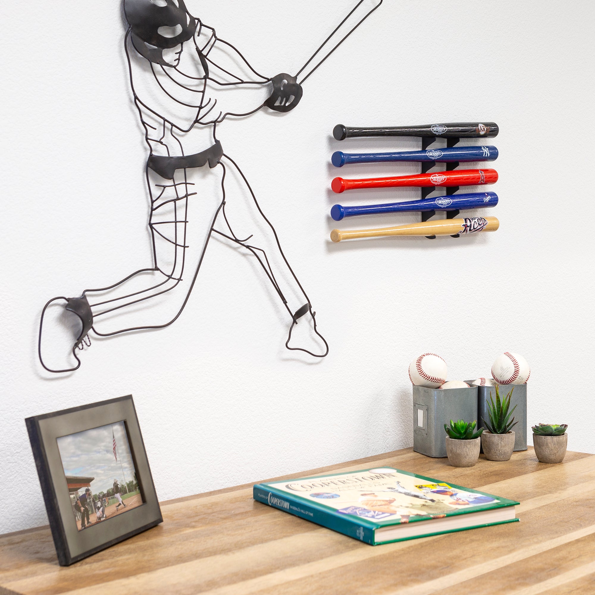 HIDEit Mini Baseball Bat Mount hanging in a room with baseball bats.