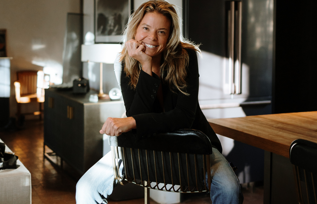 Jen smiling on a chair