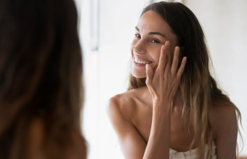 A woman putting skincare on her face