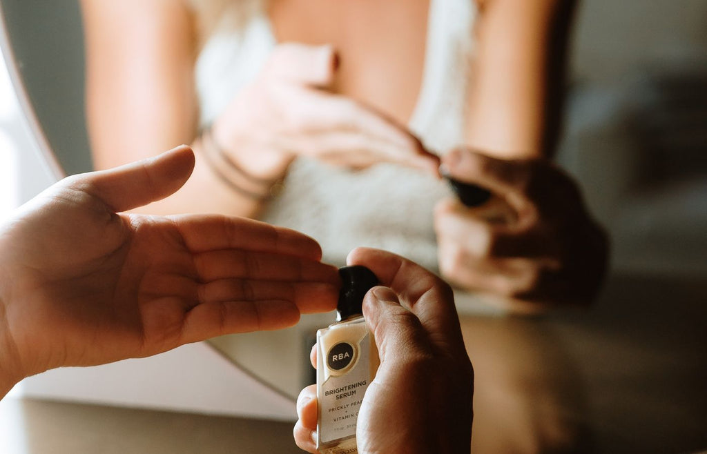 Woman applying brightening facial serum