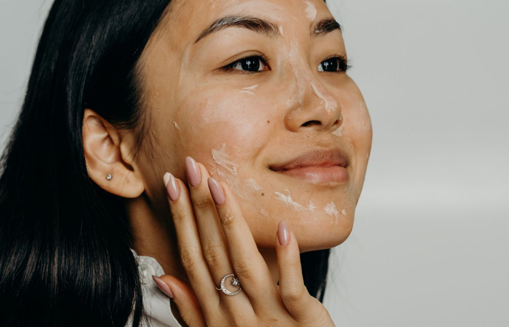 Woman exfoliating skin