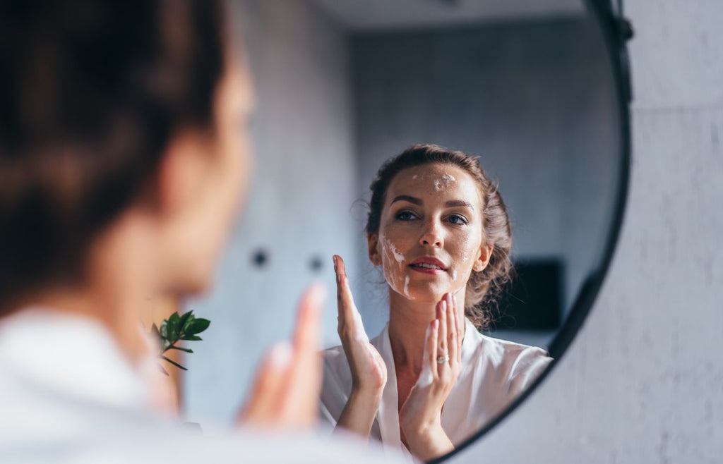 Woman polishing face in mirror