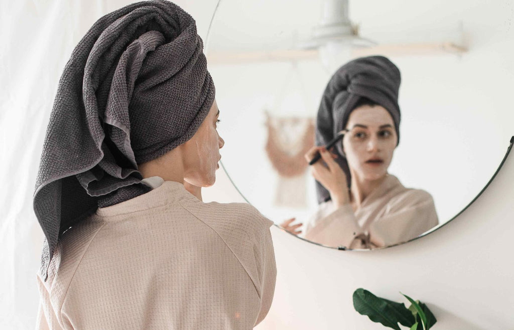 Woman applying hydrating facial mask