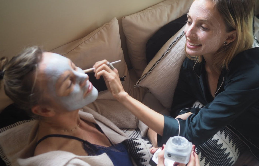 women applying facial masks