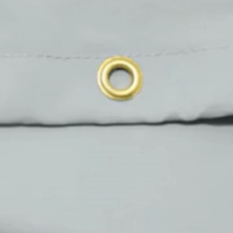 close up image of a grommet on a patio furniture cover