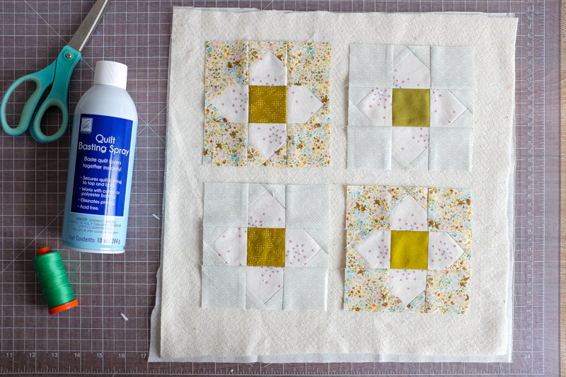 Blooming Scraps Quilt Scrappy Coasters Tutorial by The Weekend Quilter Basting multiple quilt sandwiches at a time