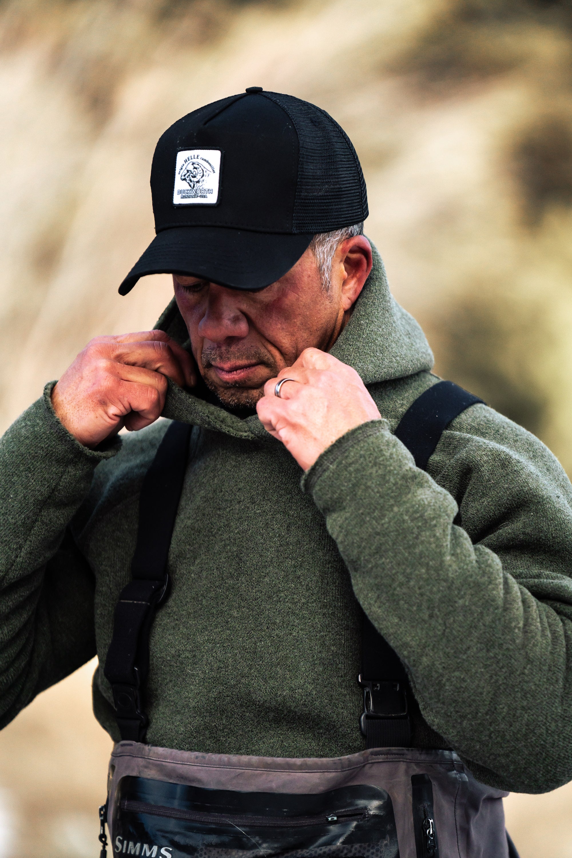 man wearing duckworth hat and powder hoodie