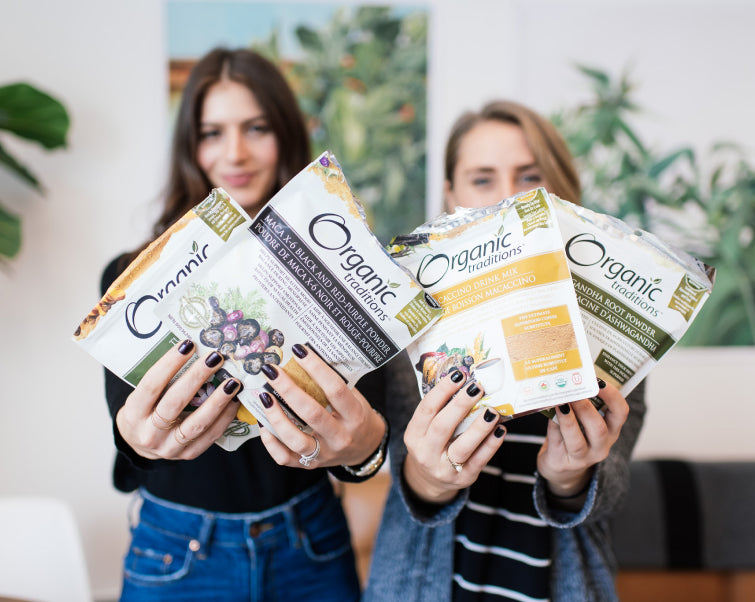 Two women holding Organic Traditions superfood products