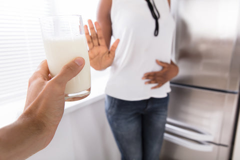 woman refusing a glass of milk