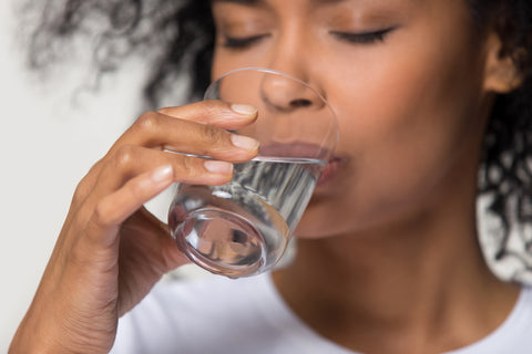 woman enjoying a glass of water