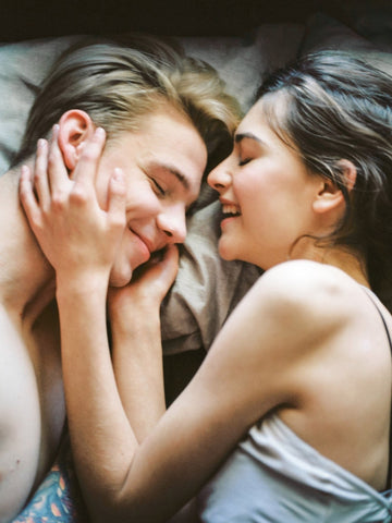 couple smiling in bed