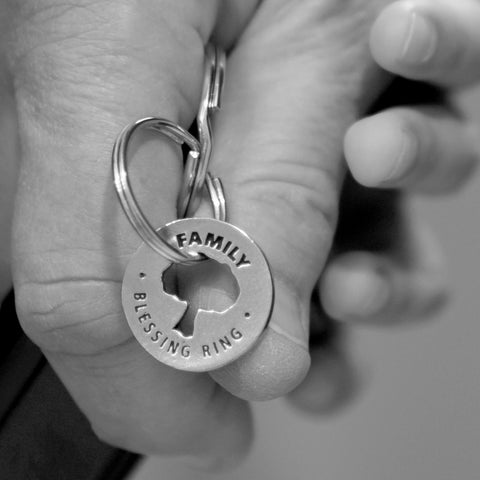 person holding family blessing ring on keyring