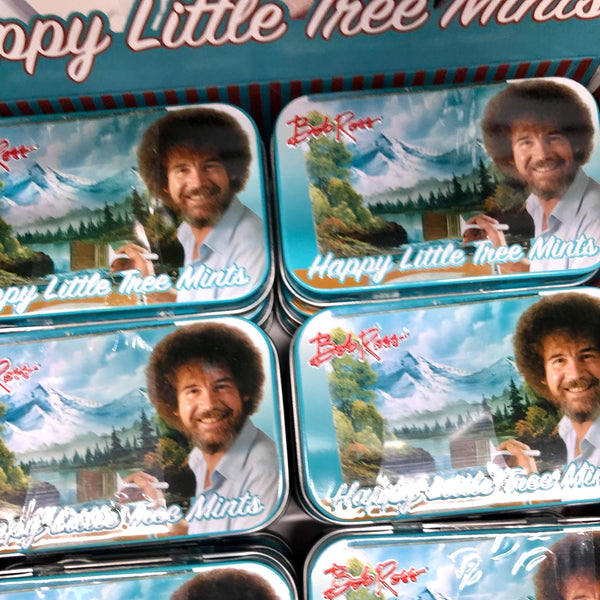 Tin cans containing mints with art Bob Ross on the lid