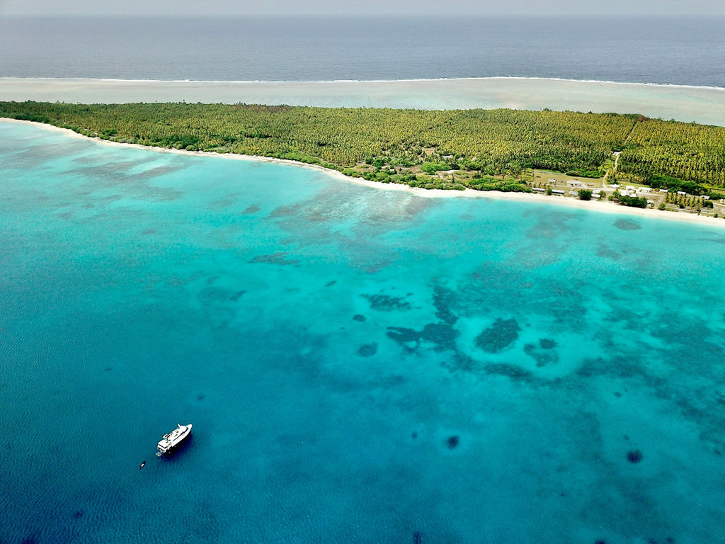 Bikini island from the air with our boat the Taka Master anchored offshore