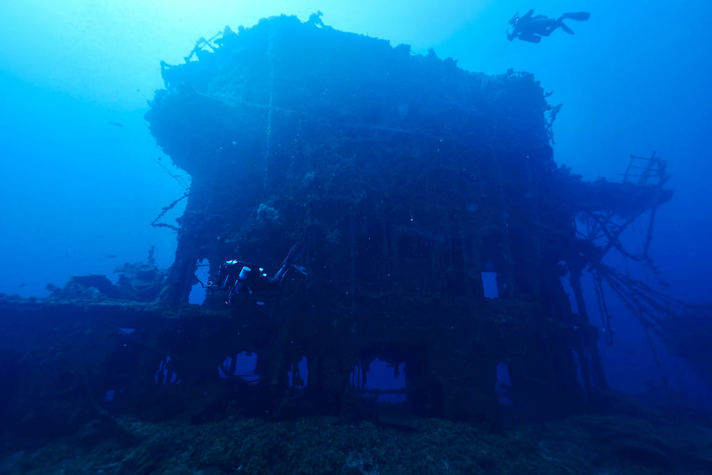 Diver at the top and one at the bottom of the bridge of the USS Saratoga in Bikini Atoll