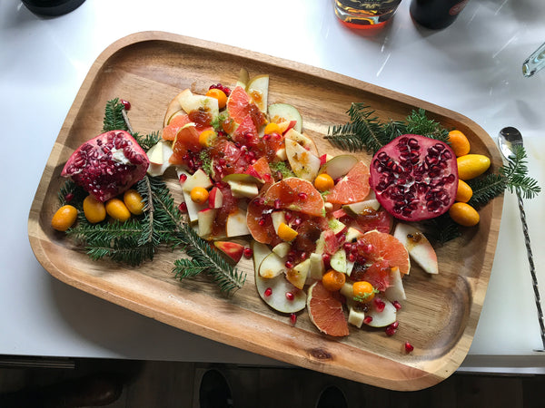 A platter of Winter Fruit Salad, pomegranate Kumquats pears grapefruit, Jam Glazed Fruit with Pueblo Chile Peach Deliciousness 