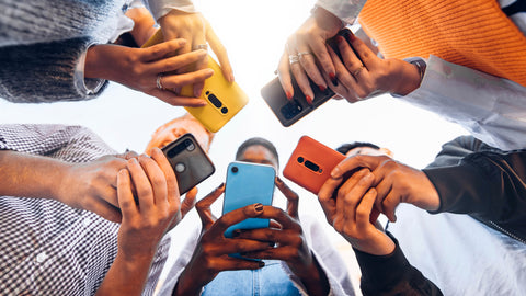 group of people looking at their phones