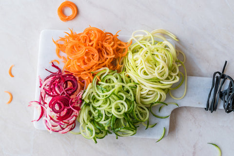 Colorful spiralized vegetables on a cutting board