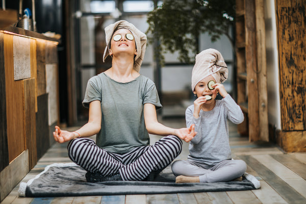 photo of mom and daughter meditating to de-stress