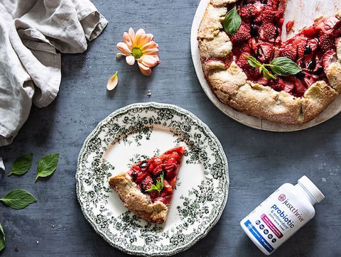 Slice of gluten-free strawberry pesto galette with Just Thrive Probiotic bottle