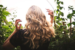 Woman with blonde hair standing outside