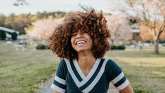 Smiling black woman sitting outside