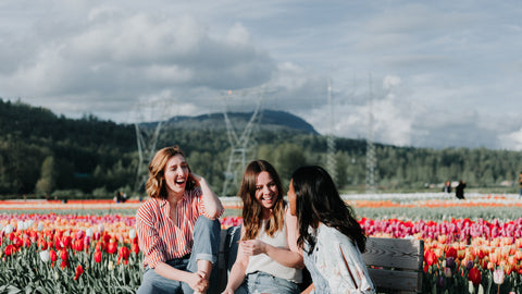 women outside smiling in a zero-waste field of flowers