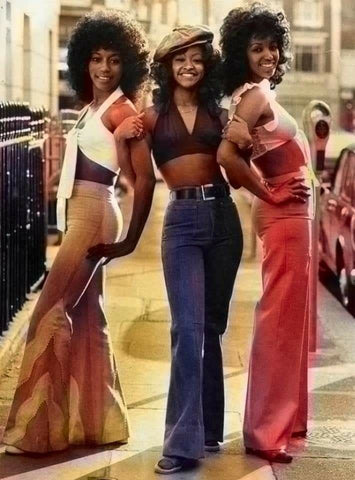3 women in 1970's clothing from soul group Three Degrees