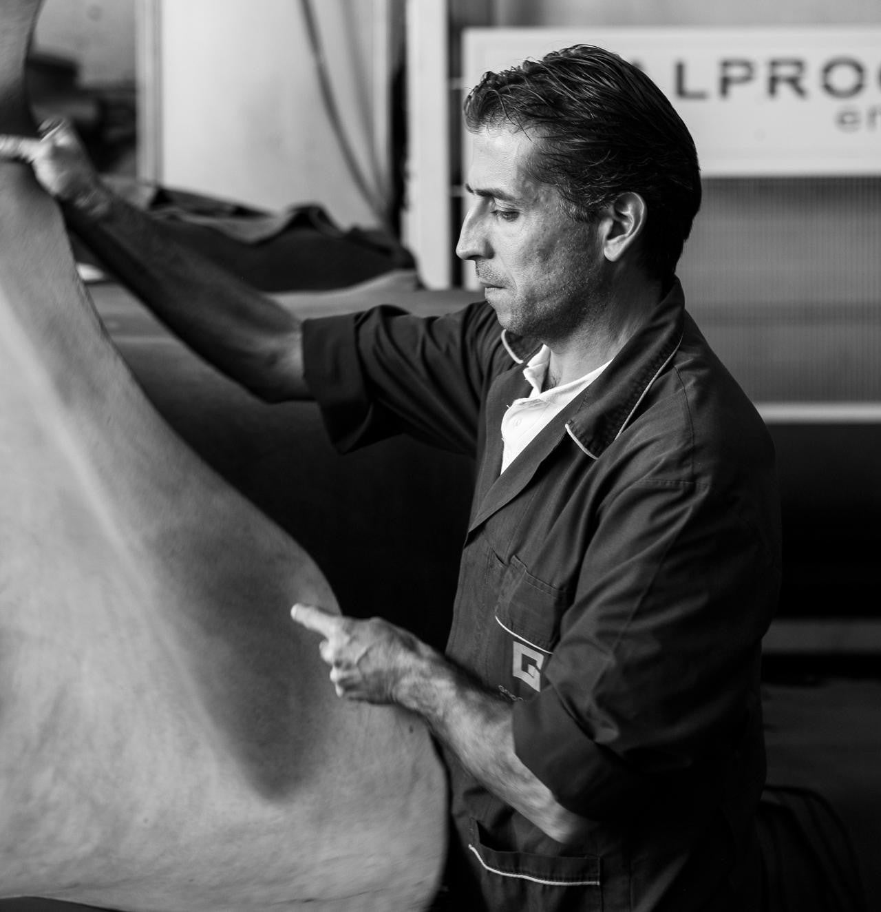 Raw piece of vegetable-tanned leather being picked up