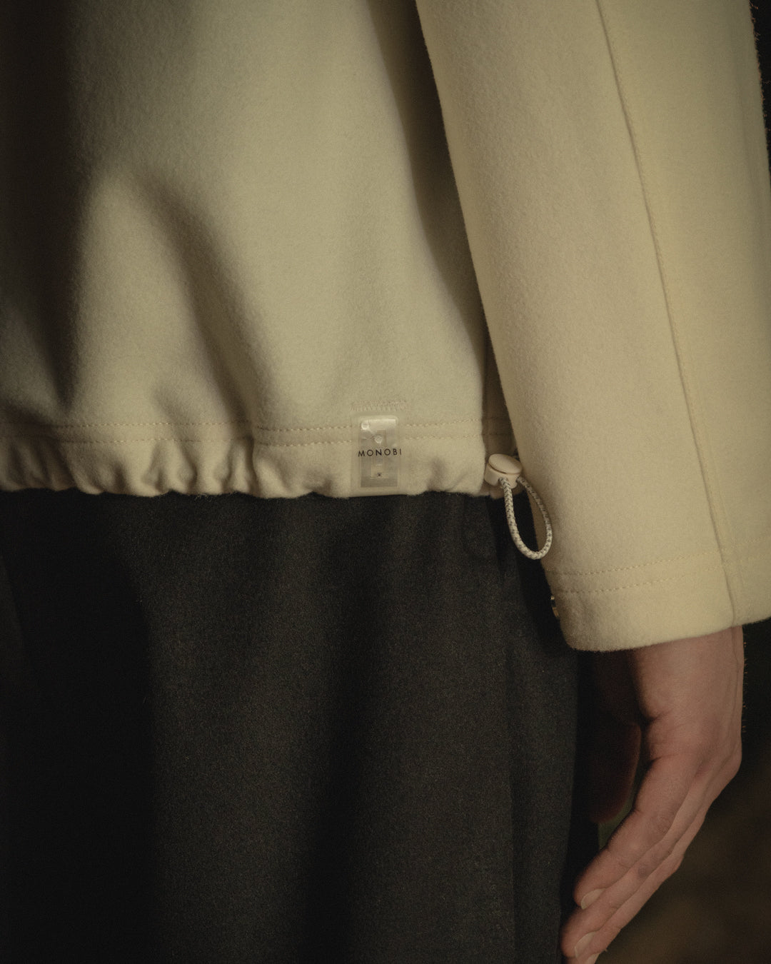 Detail of the border and NFC TAG of the MONOBI wool jacket