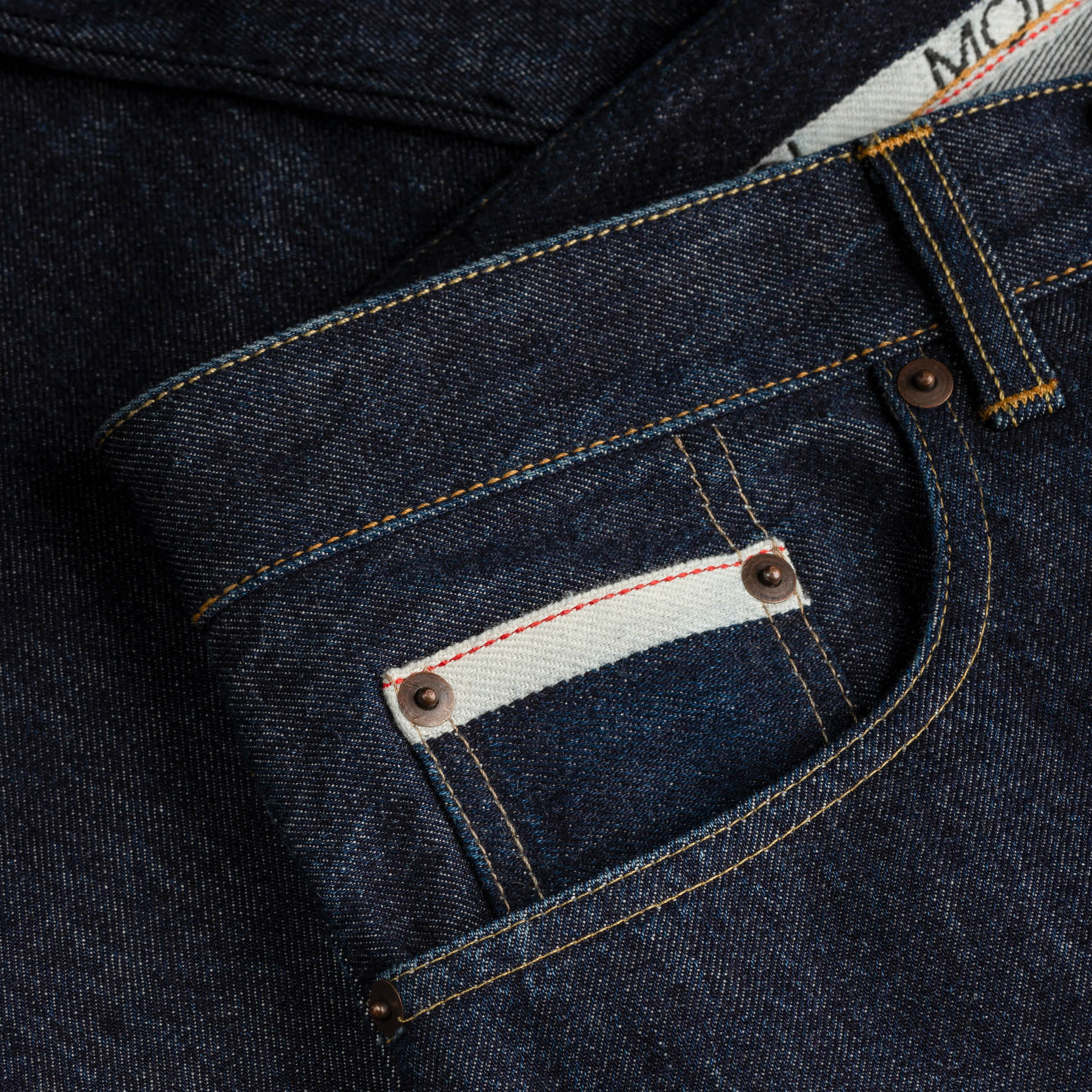 waist and pocket detail of MONOBI indigo denim trousers