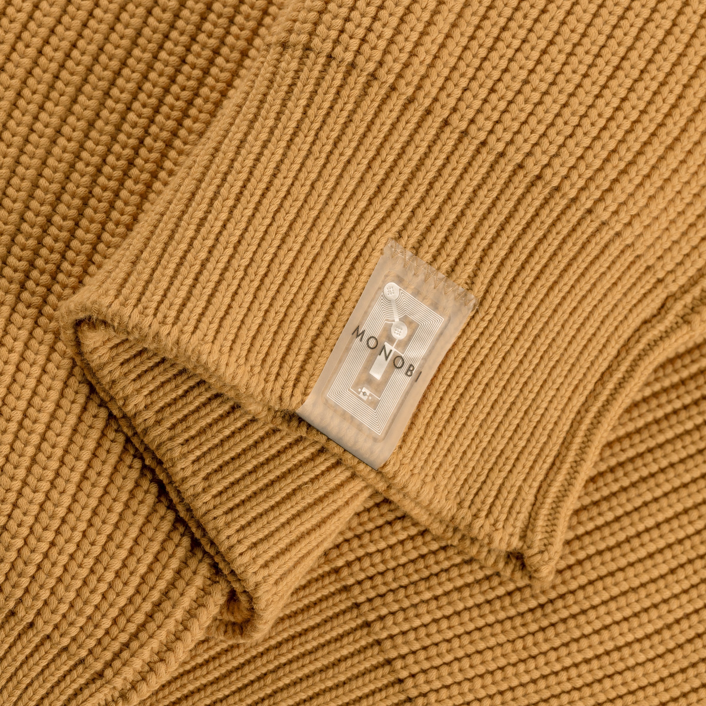 detail of the NFC TAG stitched on the bottom of the pearlised ochre model