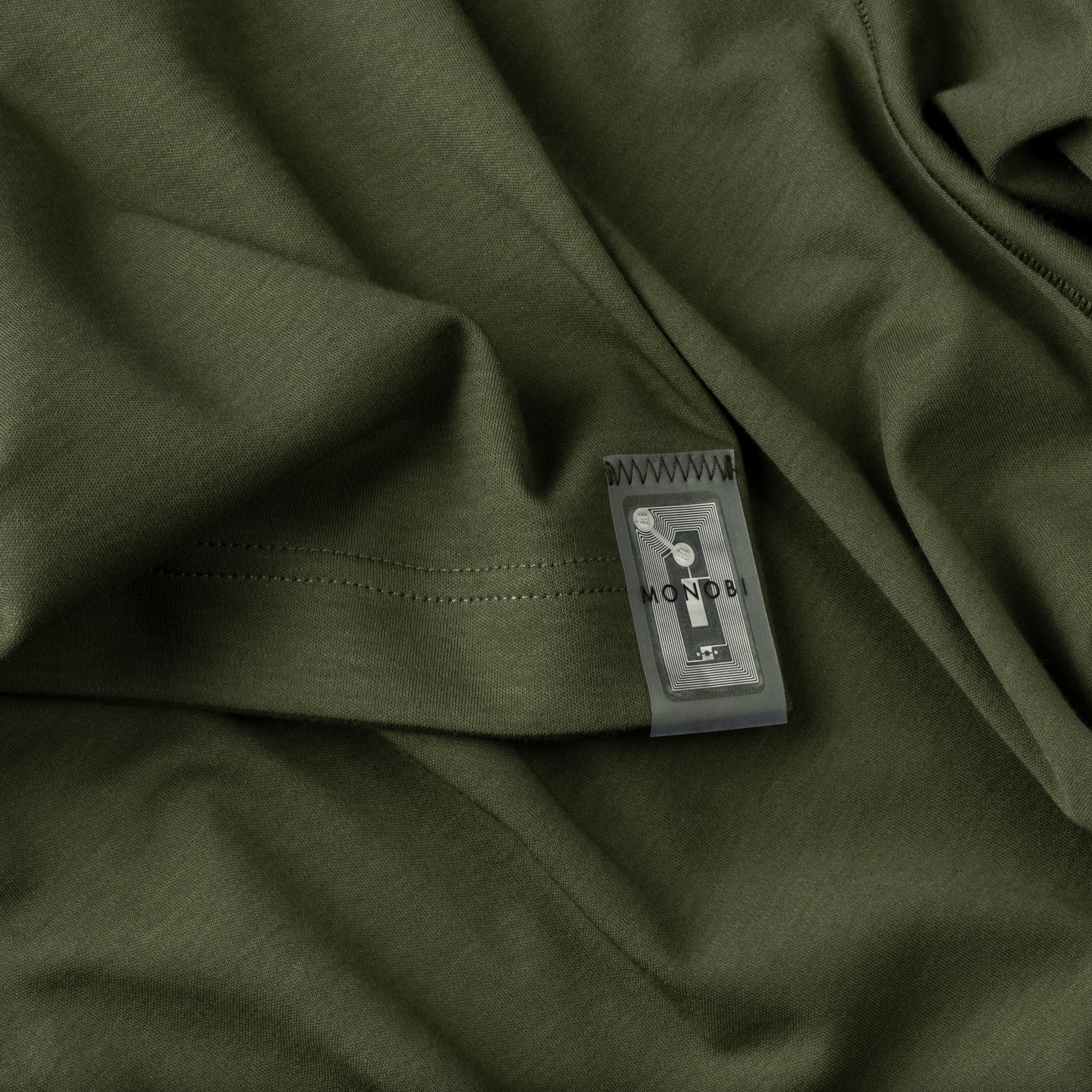 Detail of the tag sewn on the back of the green Icy Touch Tshirt