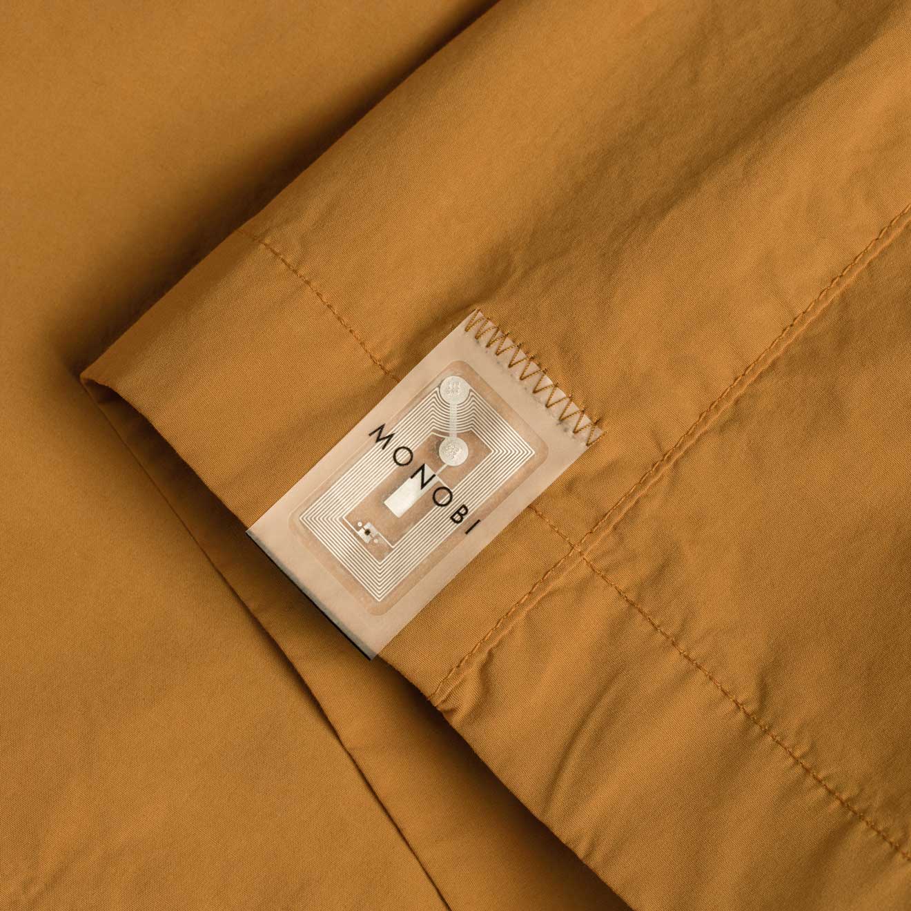 TAG NFC detail on caramel-coloured shirt