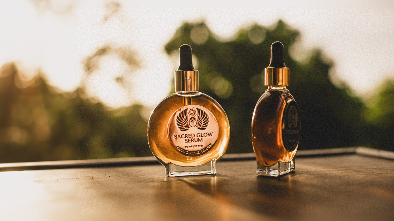 Two serum bottles with droppers against a sunlit blurry background.